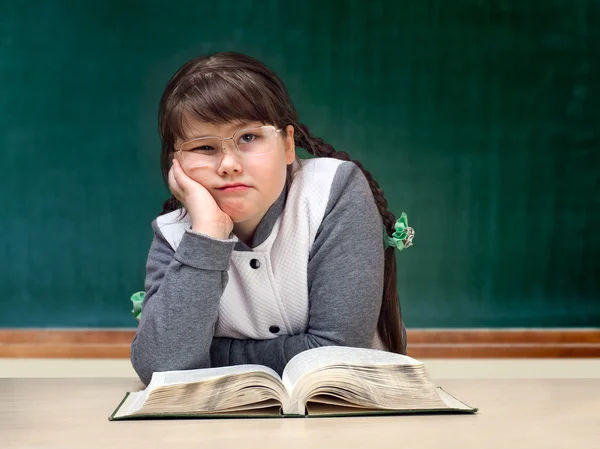 Girl in the classroom. Great tutorial, blackboard. Child obesity full. Schoolgirls boring, do not like to study