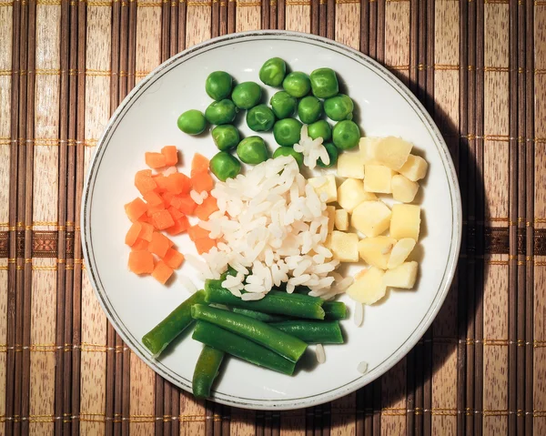 Frozen vegetables, mixed vegetables. Peas, carrots, potatoes. Vegetarian dishes. rice