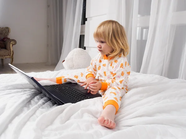 A small child with a laptop