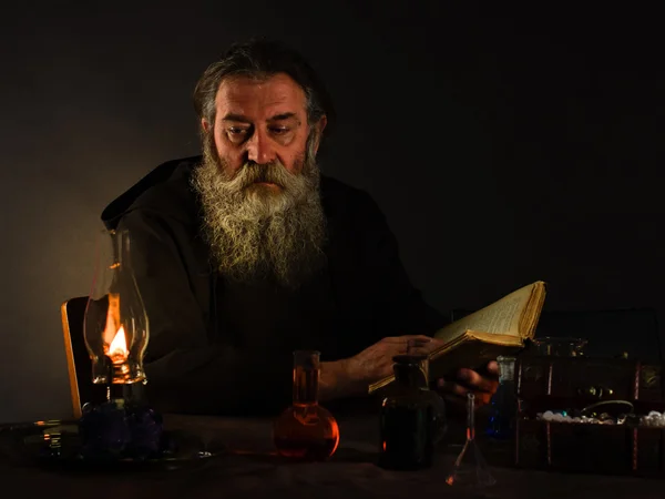 The magician or an alchemist. Ancient Tome. Laboratory alchemist