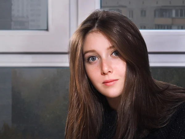 Portrait of a girl at the window