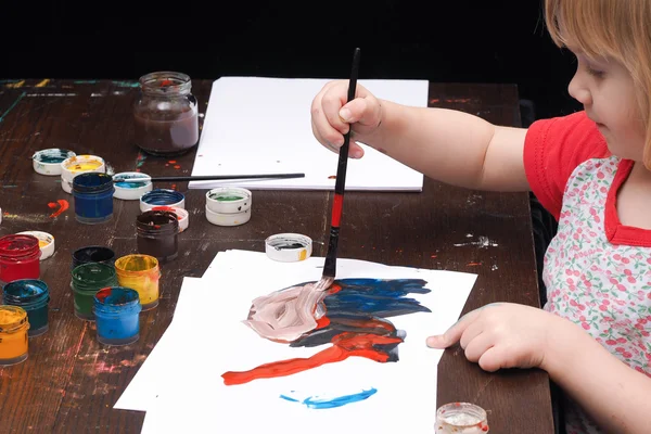 Small child draws paints