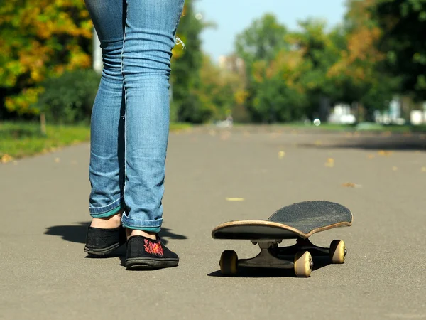 Feet in sneakers on a skateboard
