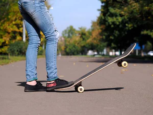 Feet in sneakers on a skateboard