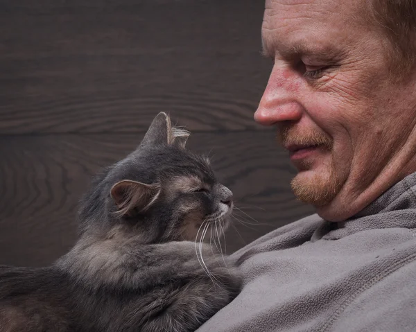 Man and cat sleeping together. Man and cat happy. Rest together