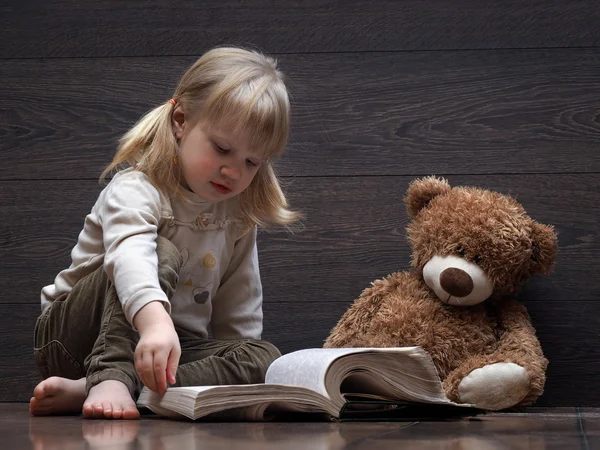 Little girl reading a book