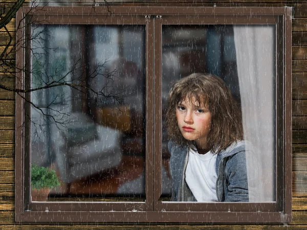 Rain, window of a house. Outside, the teen girl in the apartment.