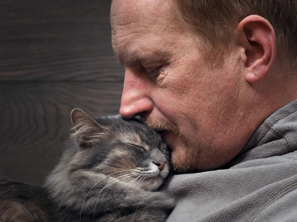 Portrait of a man with a cat