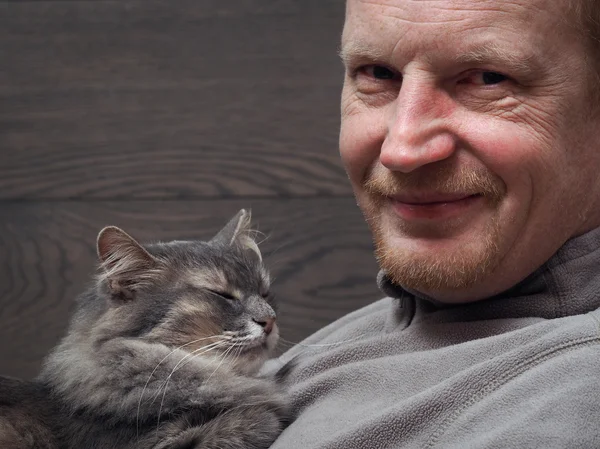 Portrait of a man with a cat