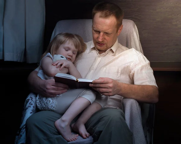 Bedtime Story. Dad daughter read a book