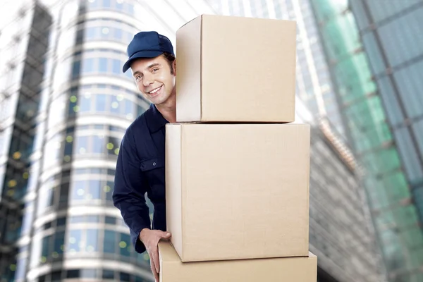 Employee lifting cardboard boxes