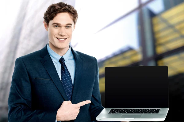 Young businessman showing laptop computer