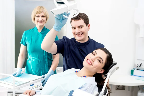 Dentist and assistant with patient