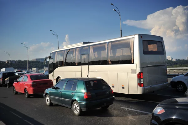 Gray coach bus in city traffic jam