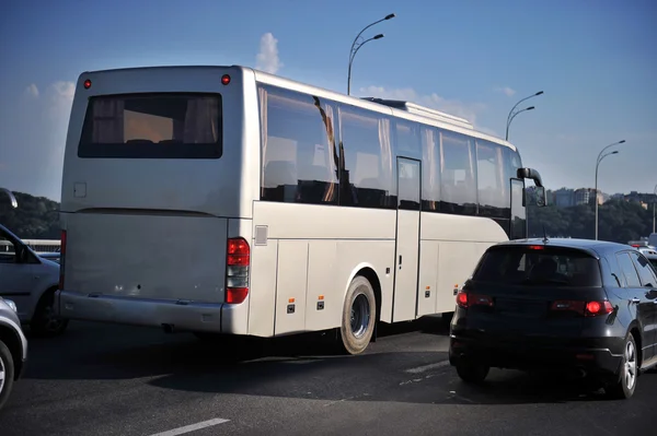 Gray coach bus in city traffic jam