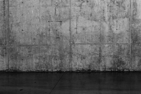 Grungy dark concrete wall and wet floor