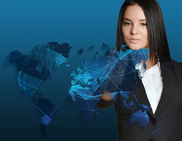 Woman in suit drawing on world map of technology networks