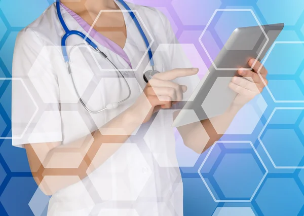 Doctor using a digital tablet on medical honecomb background
