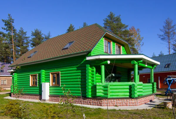 Green wooden house in the village