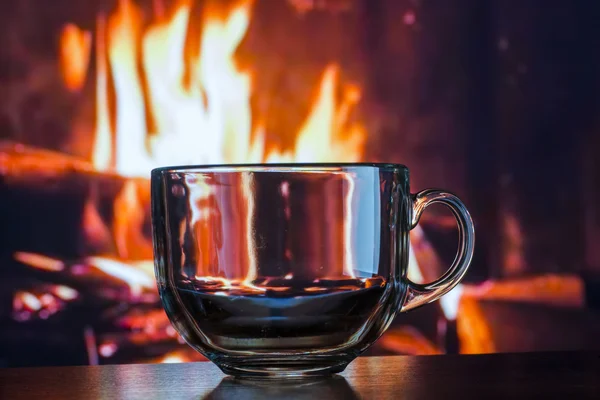 Glass transparent cup on the background of fire fire