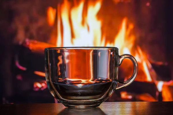 Glass transparent cup on the background of fire fire