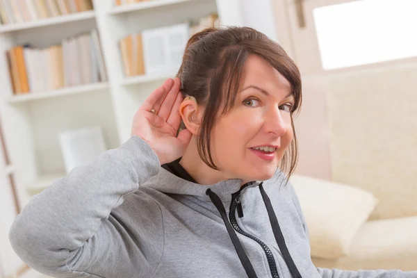 Woman wearing deaf aid