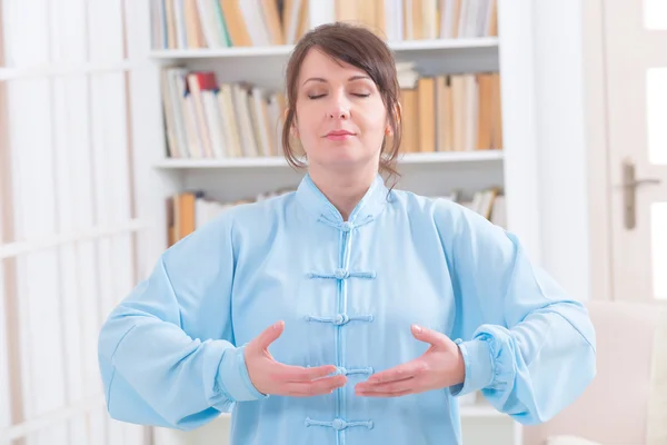 Meditating woman at home