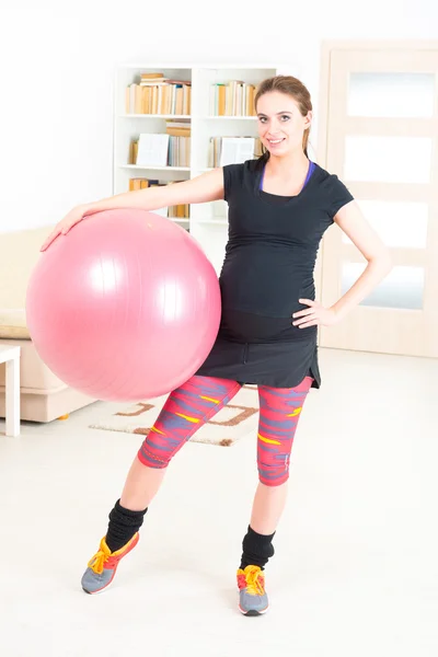 Pregnant woman exercising at home