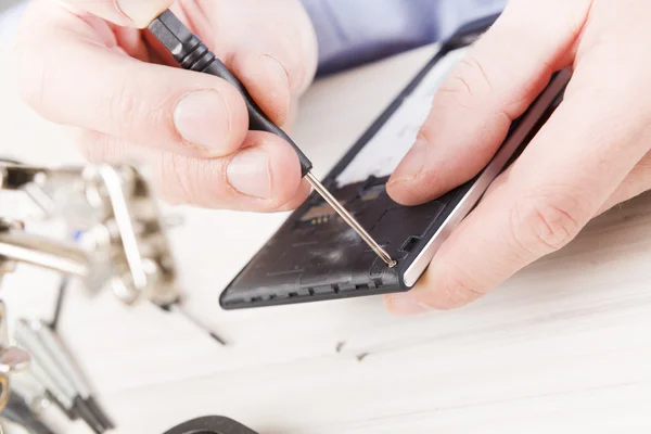 Repairing mobile phone in the electronic workshop