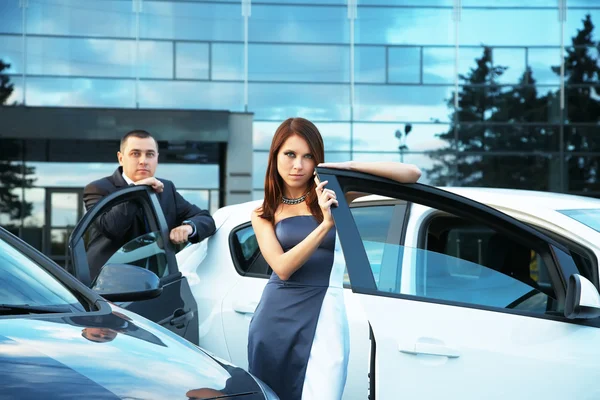 Young couple standing near the car