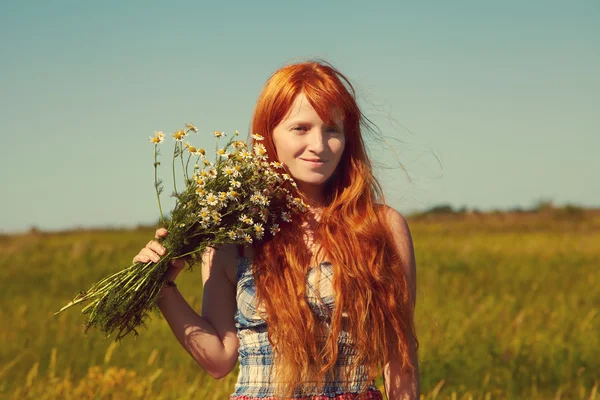 Redhead woman with a bouquet of flowers