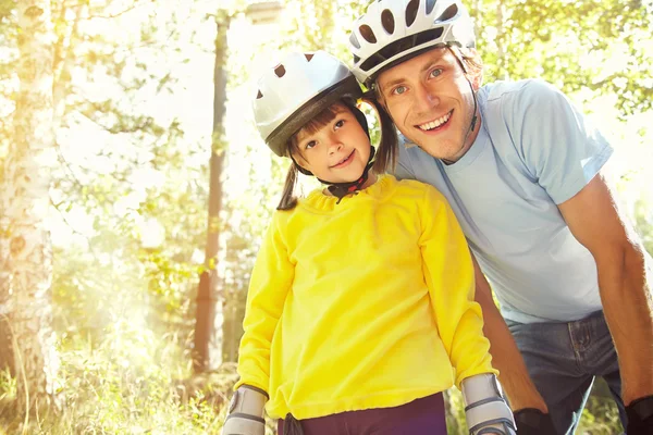 Dad and daughter in a helmet