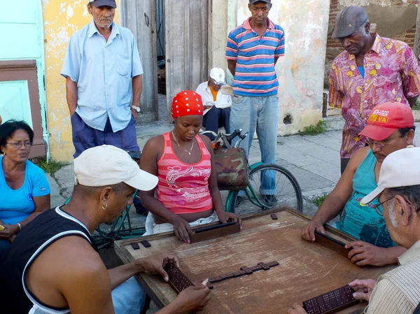 People playing dominoes in the street.