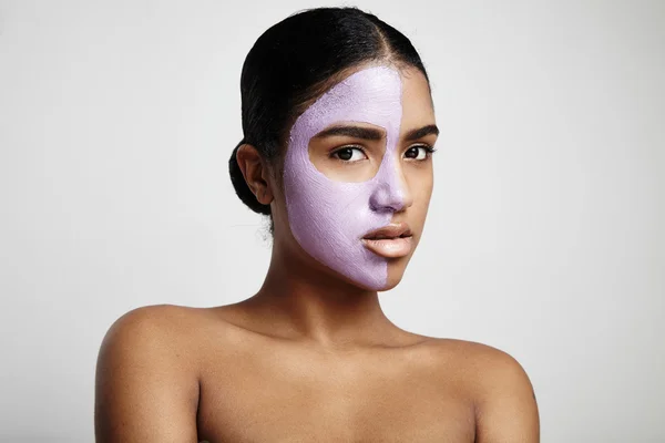 Woman with purple clay mask