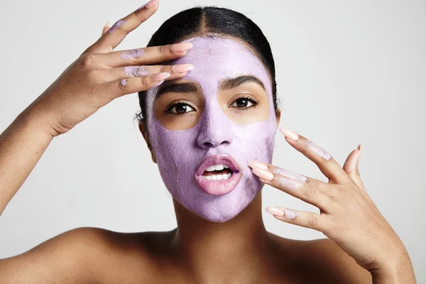 Woman with purple facial mask