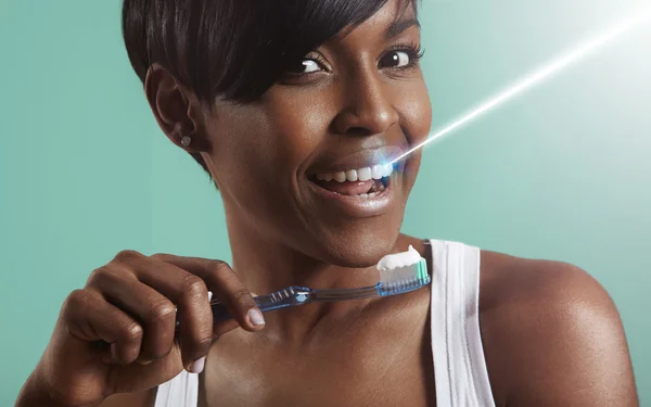 Woman whitening teeth