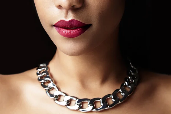 Woman with red lips and silver necklace