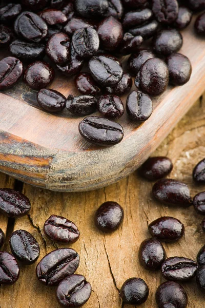 Macro shot of roasted coffee beans on wooden board