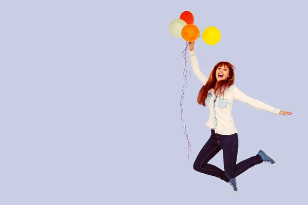 Hipster woman holding balloons