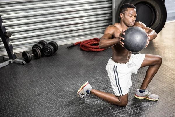 Muscular man training with medicine ball