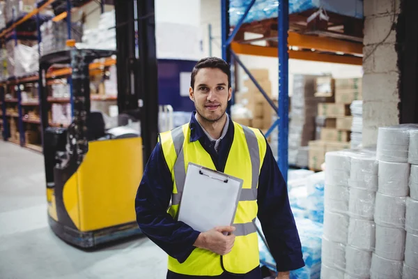 Portrait of warehouse worker with clipboard