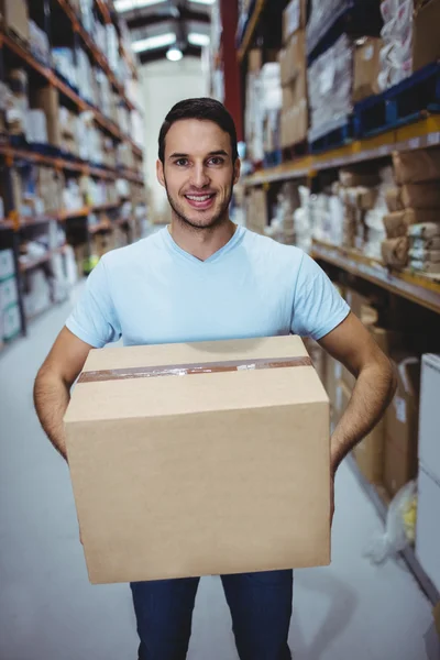 Smiling man holding big box