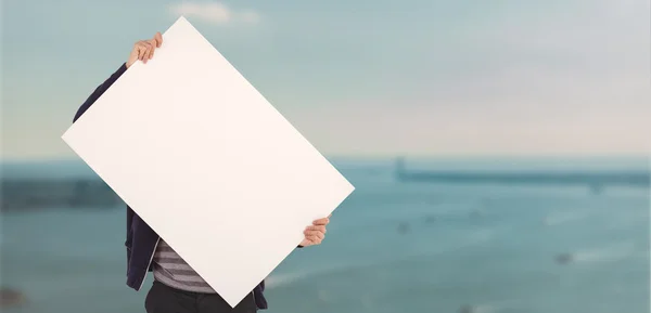 Man holding billboard in front of face