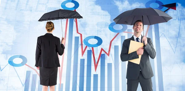 Businessman sheltering under umbrella holding file