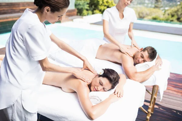 Couple receiving massage from masseur