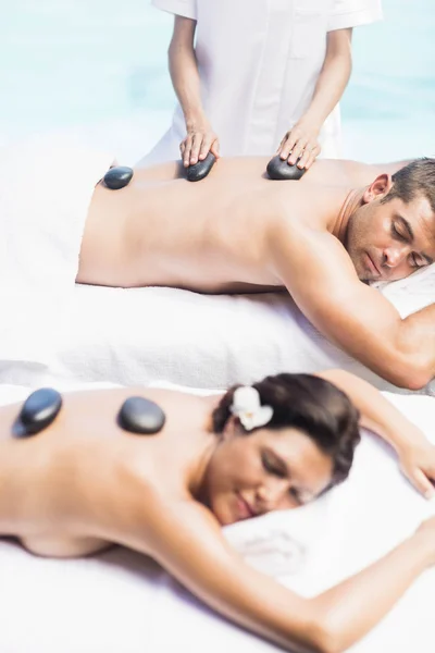 Couple getting hot stone massage