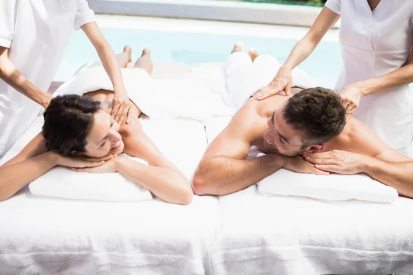 Couple receiving massage from masseur