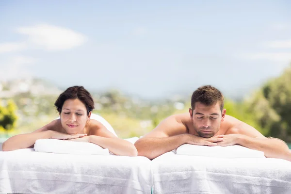 Couple relaxing on massage table