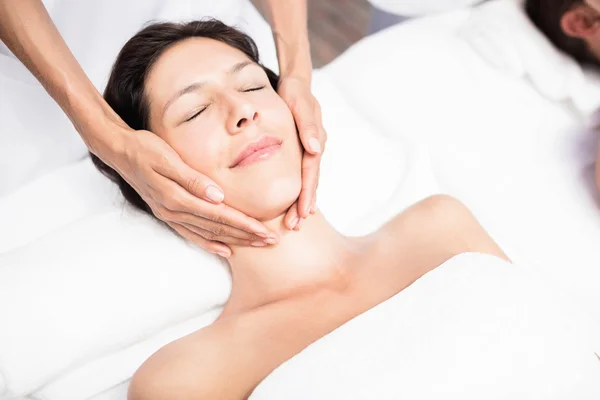 Woman receiving face massage