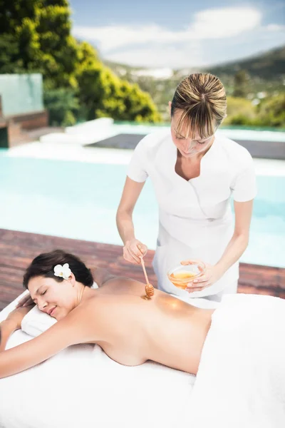 Woman receiving honey massage